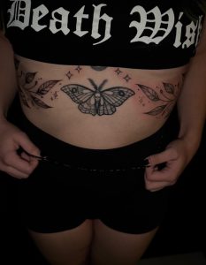 Moth tattoo on lower abdomen at Legendary Tattoos in Las Vegas, Nevada.