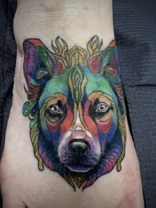 Colorful dog portrait foot tattoo by Wally at Legendary Tattoos