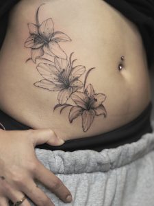 Fine line floral tattoo