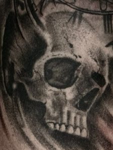 Black & Grey skull tattoo with cracks and shading throughout by Henry Fuentes in Las Vegas, Nevada.