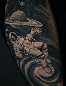 Space-themed astronaut tattoo by Henry Fuentes at Legendary Tattoos in Las Vegas, Nevada.