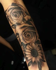 Black and grey rose sleeve tattoo by Henry Fuentes at Legendary Tattoos in Las Vegas, Nevada