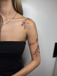 Fine line floral tattoo