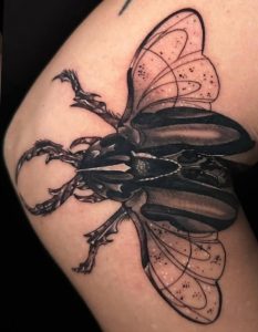 Black Beatle Arm Tattoo on arm by Lisset at Legendary Tattoos in Las vegas.
