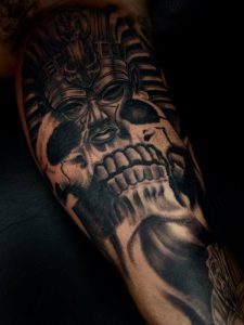 Skull Tattoo by Henry Fuentes at Legendary Tattoos in Las Vegas, Nevada. In this skull tattoo, it's combined with a king tut Egyptian tattoo, it's very detailed and black and grey as well.