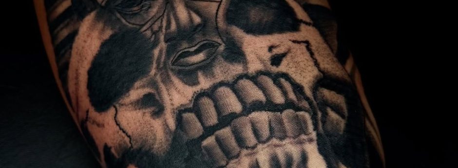 Skull Tattoo by Henry Fuentes at Legendary Tattoos in Las Vegas, Nevada. In the photo, you'll see it's a very detailed skull tattoo that's shaded with black and grey.