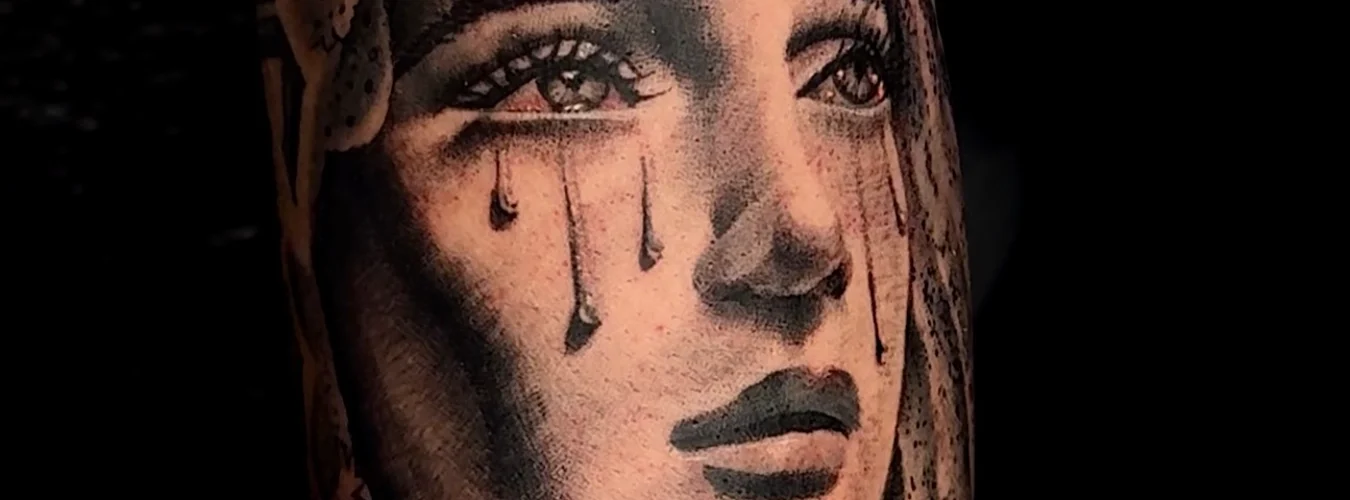 Mother Mary crying black and grey realism tattoos by Legendary Tattoos in Las Vegas.