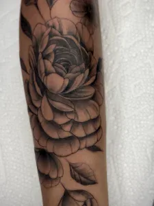 Multipetaled floral tattoo with sharing on each petal by Legendary Tattoos in Las Vegas